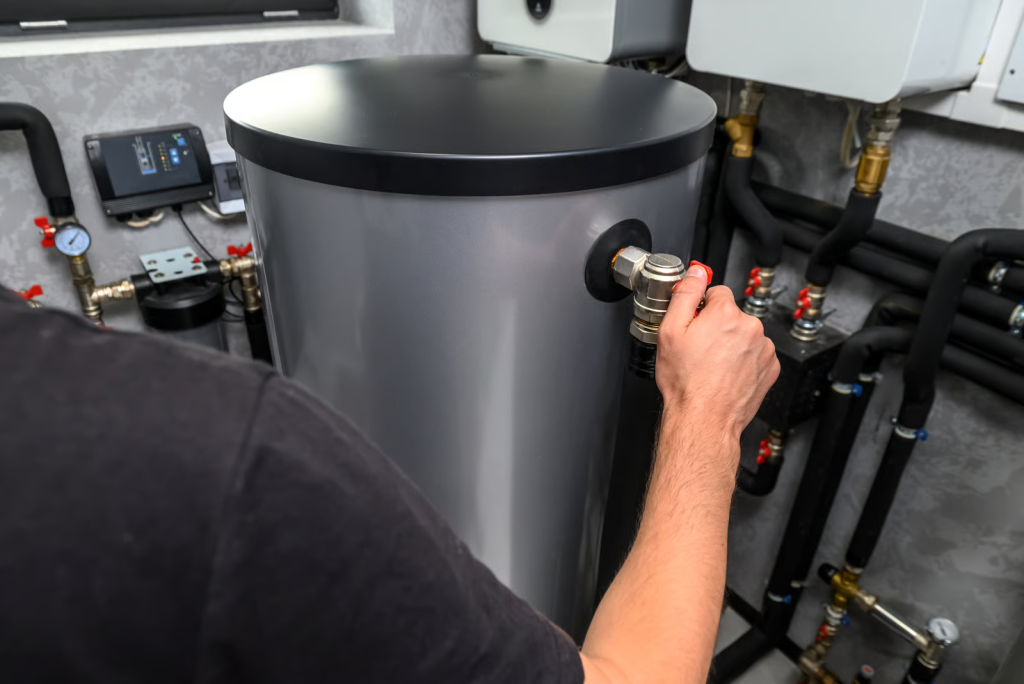 Plumbing services inspecting a home water heater for problems.